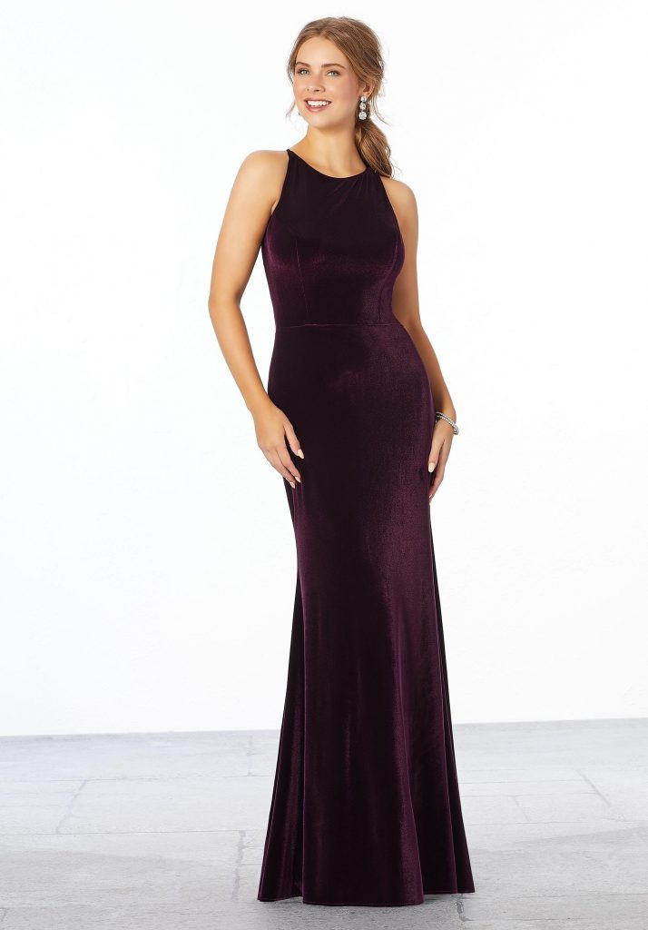 Young woman wearing stretch velvet sheath bridesmaid dress with a high neckline