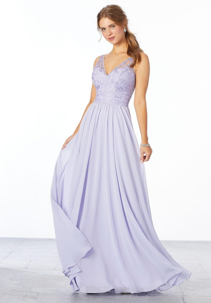 Young woman wearing eminine clilac chiffon bridesmaid dress with an embroidered bodice and flowing A-line skirt