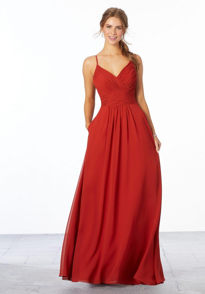 Young woman wearing A-line cinnamon chiffon bridesmaid dress with a ruched, v-neck bodice, and ruched waistband
