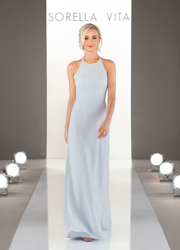 Model on runway wearing pale blue long formal dress with halter neck