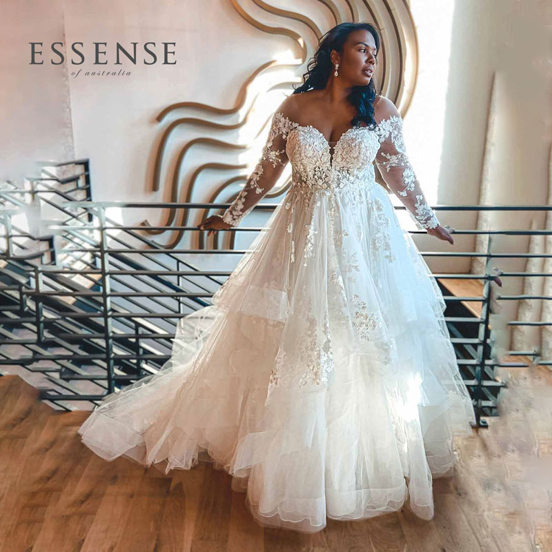 https://wendysbridalcincinnati.com/wp-content/uploads/2021/02/wedding-dress-plus-size-ballgown-tiered-skirt-Essense-D3274-square-logo.jpg