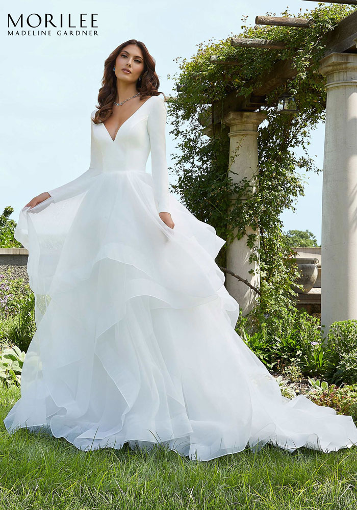 Ballgown wedding dress with long sleeves and tiered skirt