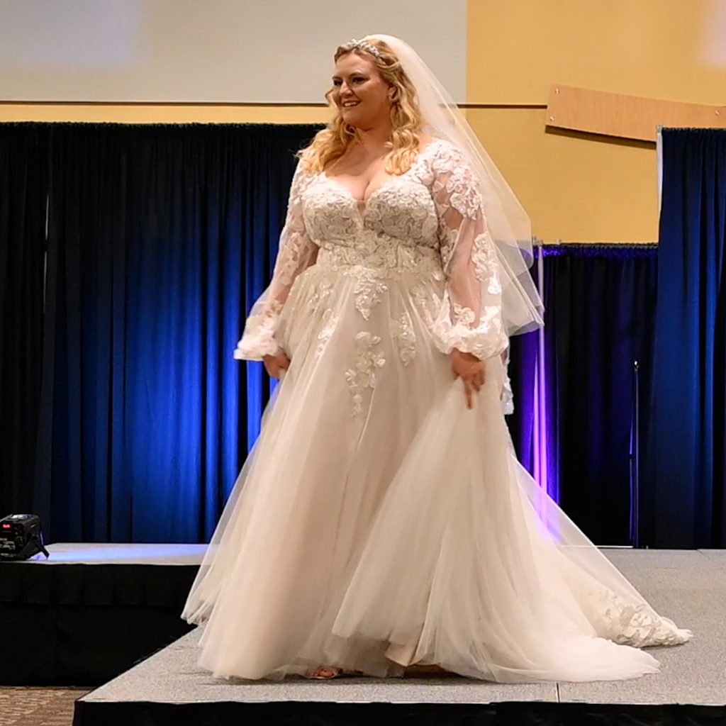 Plus-Size ballgown wedding dress with long sleeves and veil
